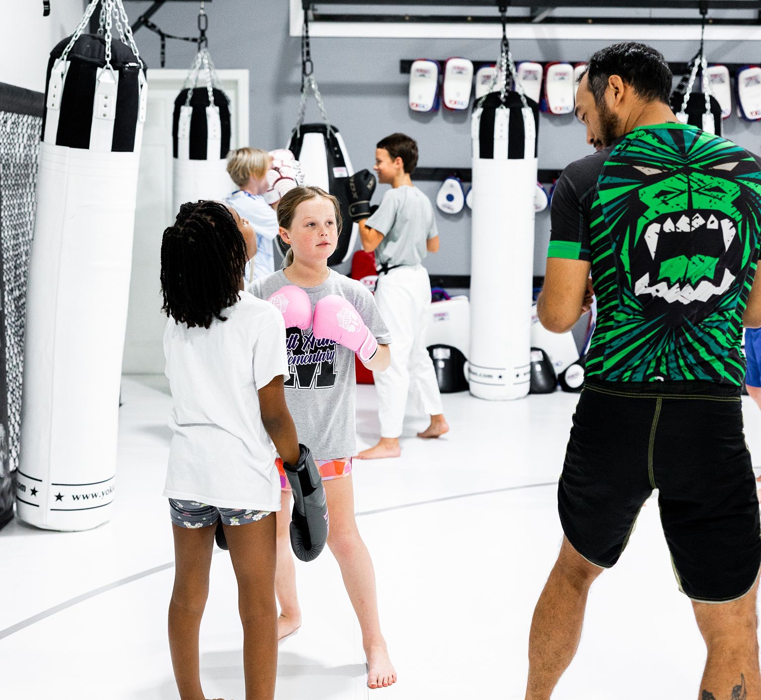 Coaches working with young students at Miller Martial Arts